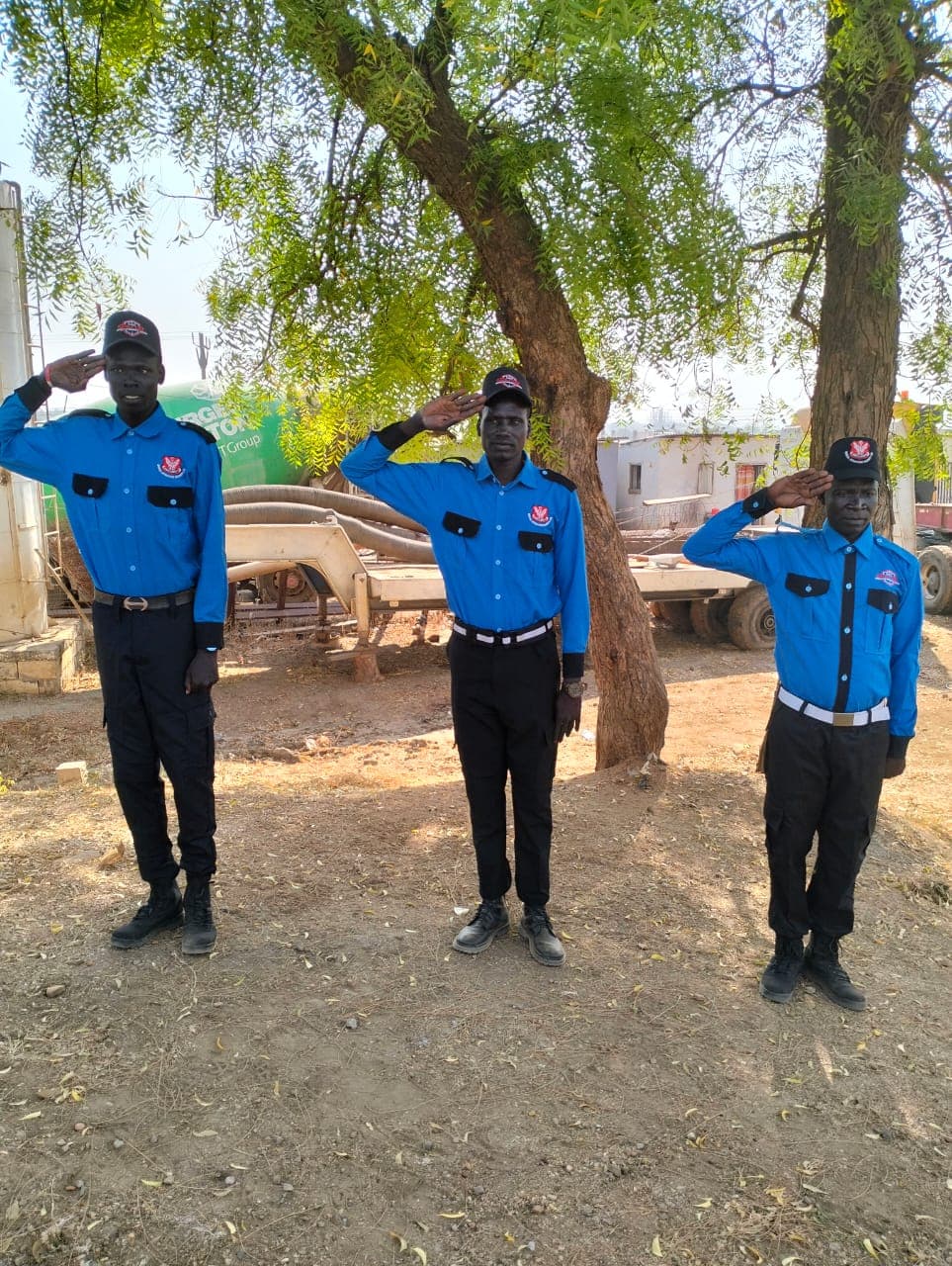 SDSL guards saluting in formation under trees on site